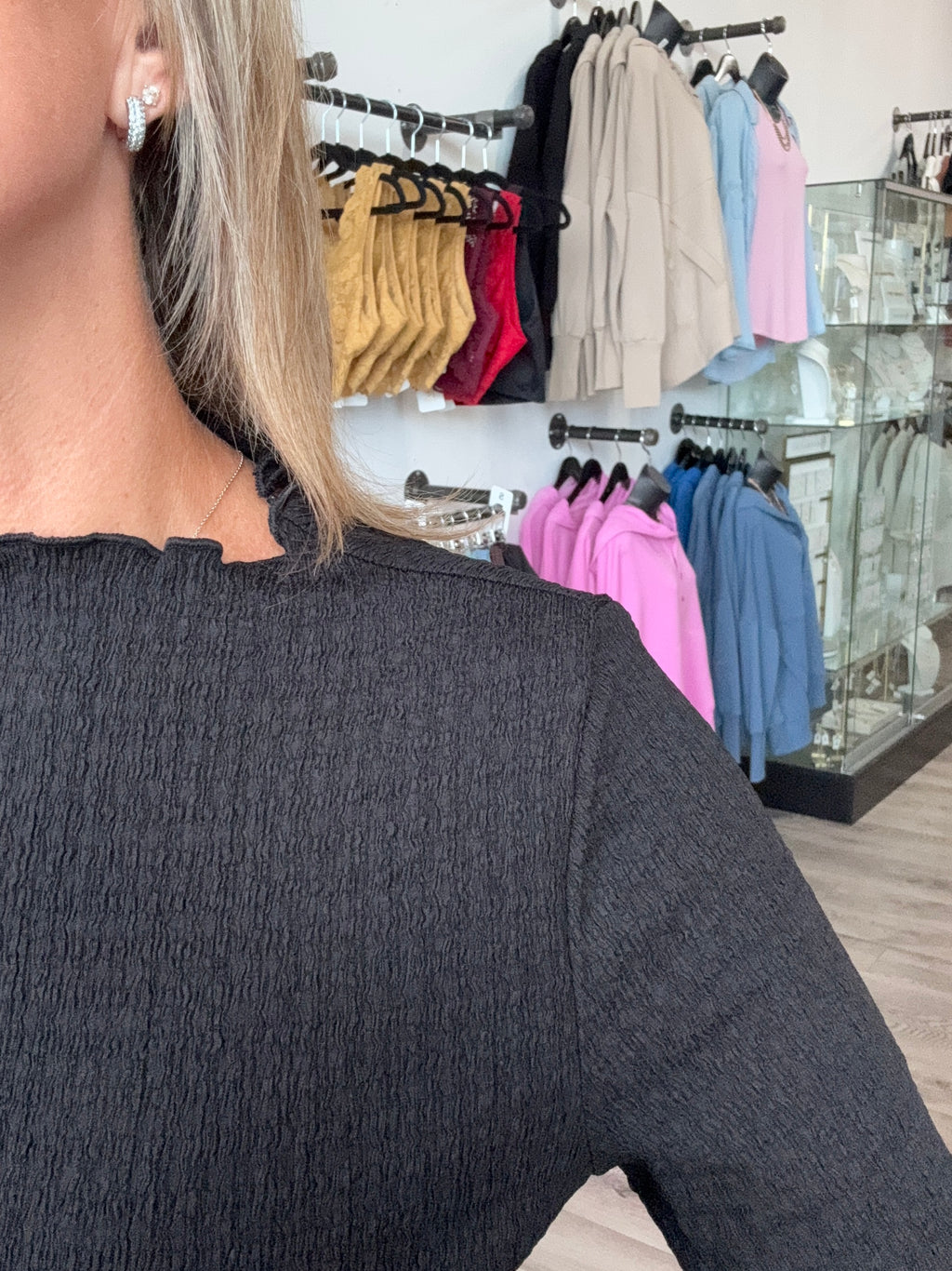 Long sleeve, textured black mock neck top.