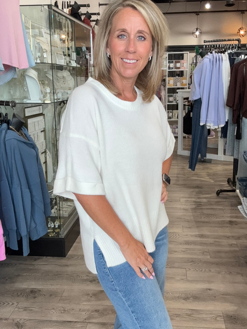 Cream colored short sleeve sweater with a side slit.
